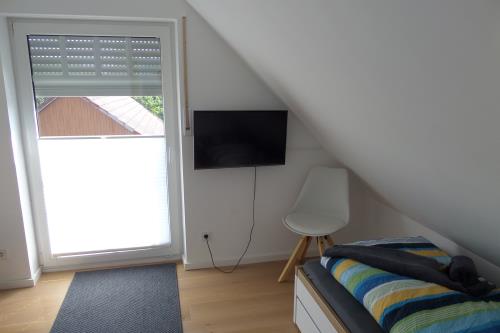 Borkum Trientjes Ferienhaus - Schlafzimmer 3, Bett + Ausziehcouch